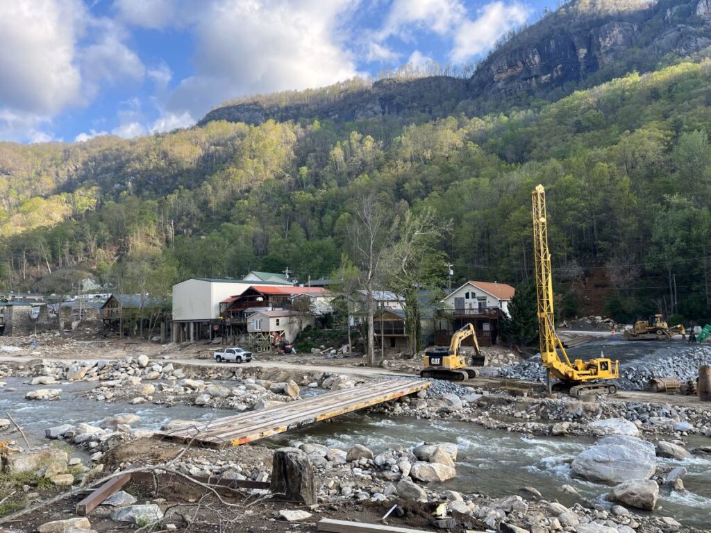 Construction crew building a temporary cross across Rocky Broad River